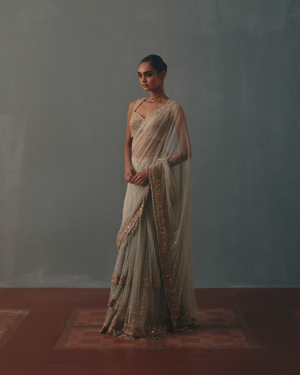 Ice Blue And Rose Gold Hand Embroidered Net Sari And Sleeveless  Blouse