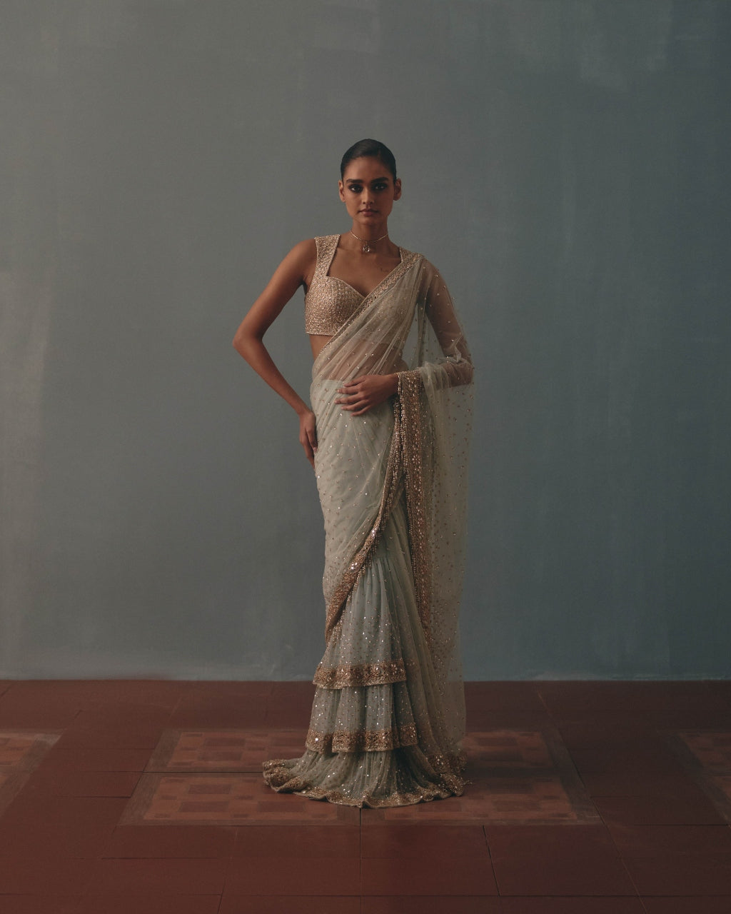 Ice Blue And Rose Gold Hand Embroidered Net Sari And Sleeveless  Blouse