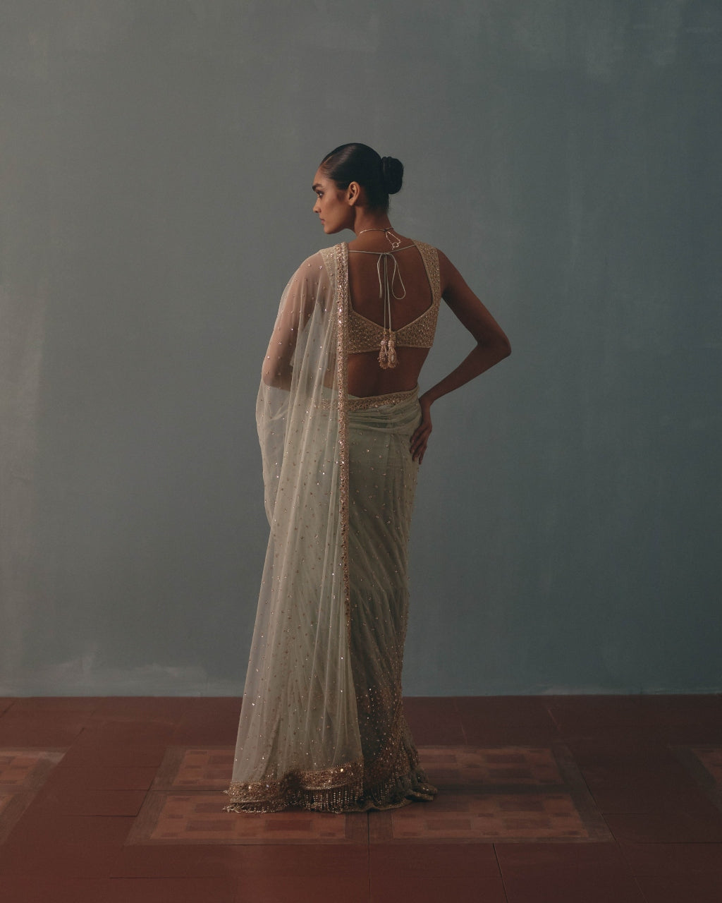 Ice Blue And Rose Gold Hand Embroidered Net Sari And Sleeveless  Blouse