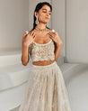 Ivory Embroidered Lehenga with Gold Blouse by Ritika Mirchandani at KYNAH